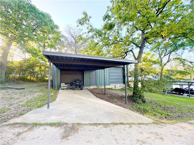 View of parking / parking lot featuring a garage | Image 21