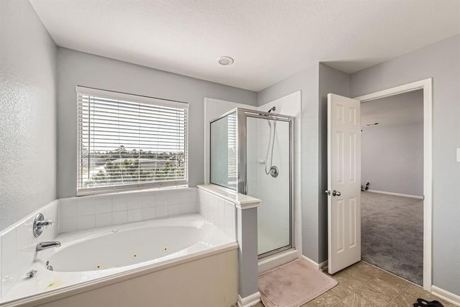 Luxurious en suite with double sinks, a soaking tub, and a separate shower. | Image 16