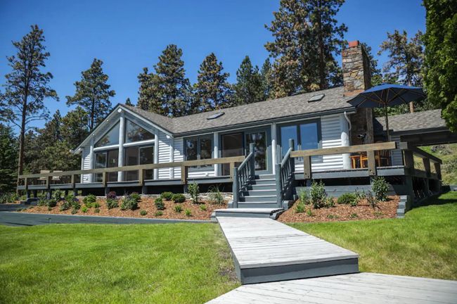 View of front of home with a deck and a front lawn | Image 8