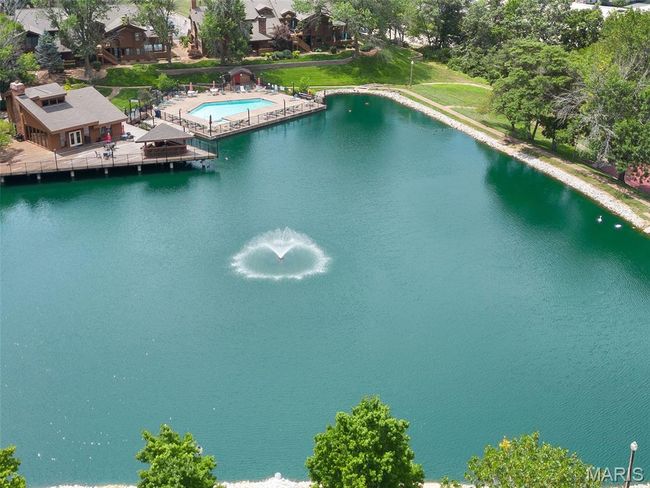 Drone / aerial view of a pool area and a large body of water | Image 33