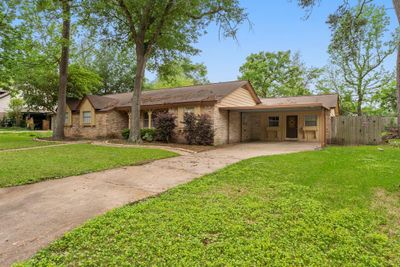 Spacious front yard with fenced in back yard and covered parking | Image 2