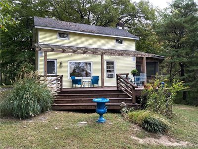 Rear view of property featuring a wooden deck and a yard | Image 3