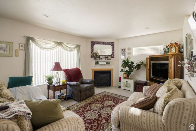 Carpeted living room with a fireplace with flush hearth | Image 5