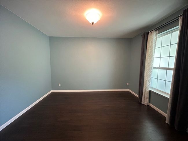 Unfurnished room featuring dark wood-style floors and baseboards | Image 6