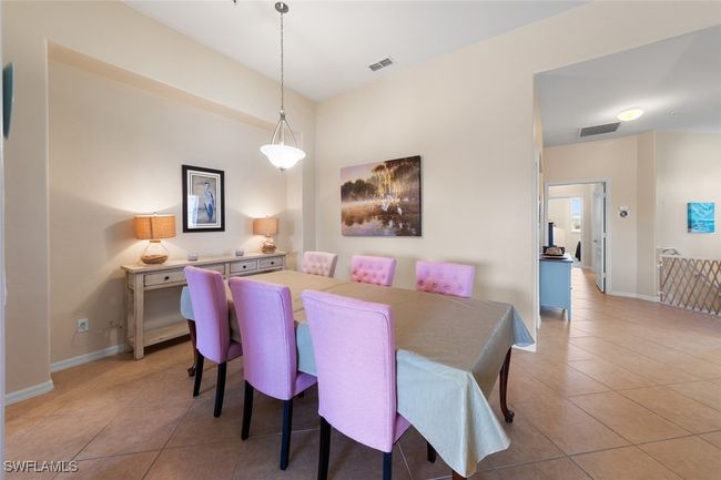 Dining space with baseboards, visible vents, and light tile patterned floors | Image 12
