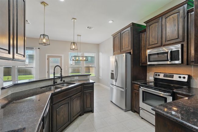 Upgraded kitchen with granite countertops, upgrades cabinetry and more | Image 4