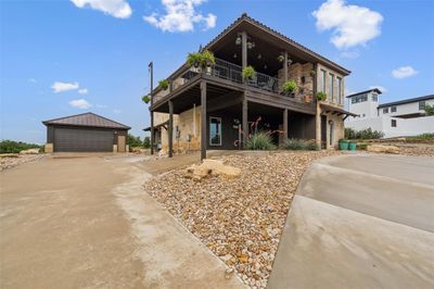 View of front facade with an outdoor structure and a garage | Image 2