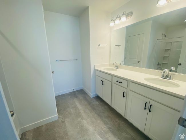 Bathroom with double vanity and a shower | Image 14
