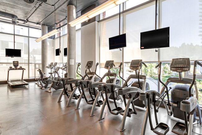 Gym featuring a towering ceiling, healthy amount of natural light, and floor to ceiling windows | Image 25