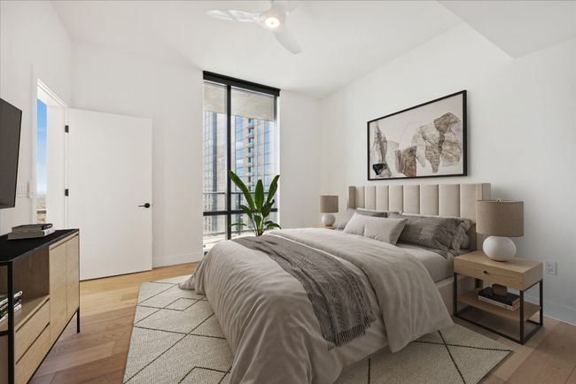 Bedroom featuring light wood finished floors, expansive windows, and a ceiling​​‌​​​​‌​​‌‌​‌‌​​​‌‌​​‌‌​‌​​​​​‌ fan | Image 10