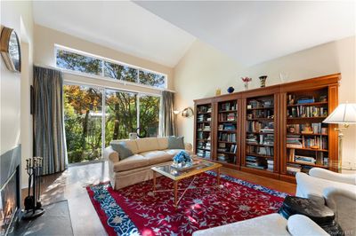 Sun drenched Living room featuring high vaulted ceiling and wood-type flooring | Image 3