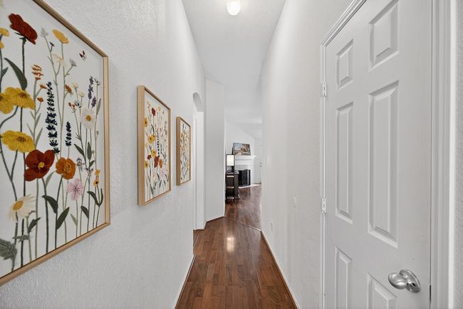 Corridor with dark wood-style floors and a textured wall | Image 8