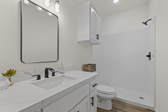 Bathroom featuring toilet, vanity, wood-type flooring, and walk in shower | Image 28