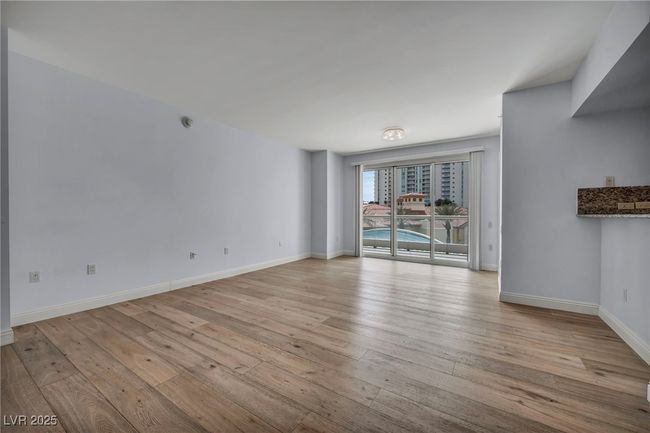 Unfurnished living room with baseboards and light wood-style floors | Image 19