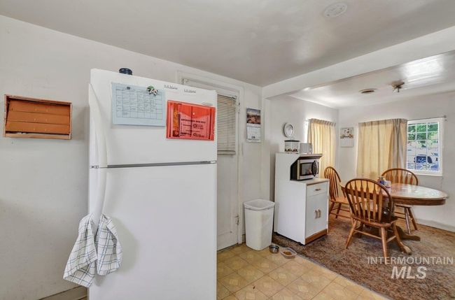 Kitchen with freestanding refrigerator and stainless steel microwave | Image 7