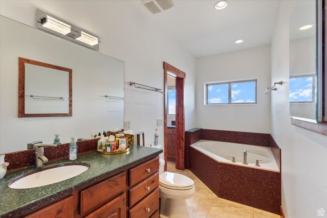 Full bathroom featuring a garden tub, vanity, toilet, visible vents, and recessed lighting | Image 11