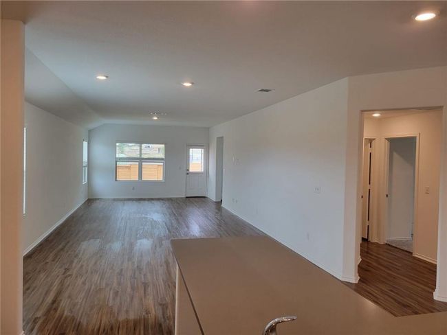 Unfurnished room with wood finished floors, recessed lighting, and vaulted ceiling | Image 8