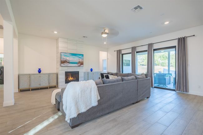 A spacious living room with a welcoming fireplace that provides warmth during the cold season. | Image 8