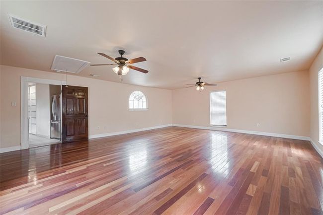 This large open room past the kitchen could be a 5th bedroom, game room, media room or add a pool table for extra fun. | Image 45