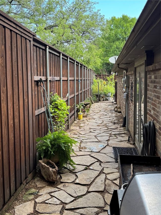 Fenced backyard with a patio | Image 33