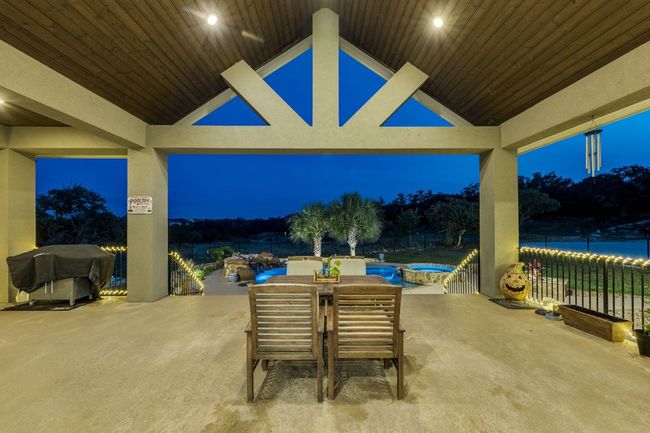 Patio at twilight featuring a patio, a grill, outdoor dining area, and an outdoor hot tub | Image 28