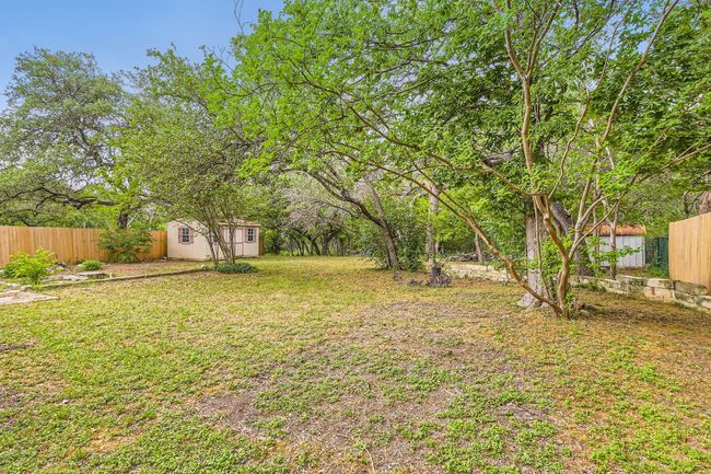 View of yard featuring an outbuilding, a fenced backyard, and a shed | Image 25