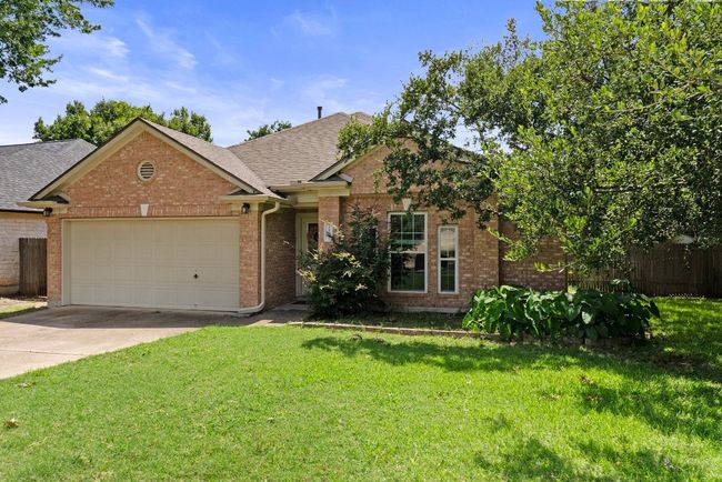 View of front of house with brick siding, a garage, concrete driveway, and a shingled roof | Image 30
