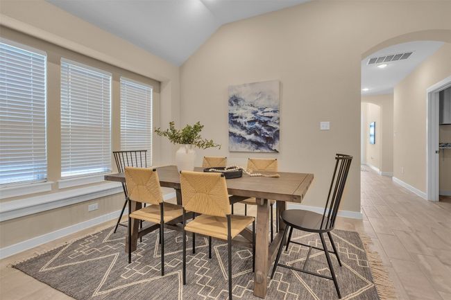 Dining space featuring arched walkways, lofted ceiling, plenty of natural light, and recessed lighting | Image 13