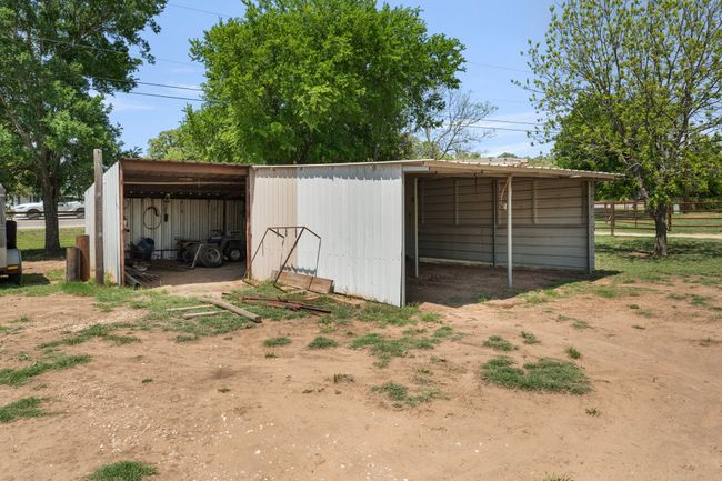 View of pole building with fence, driveway, and a carport | Image 30