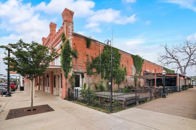 View of building exterior featuring a fenced front yard | Image 13