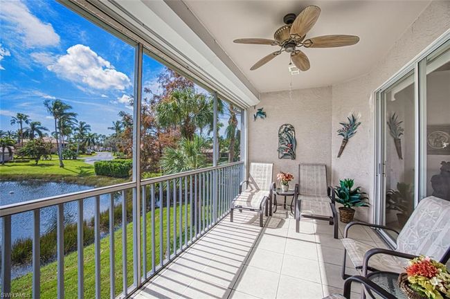 Sunroom / solarium featuring ceiling fan and a water view | Image 17