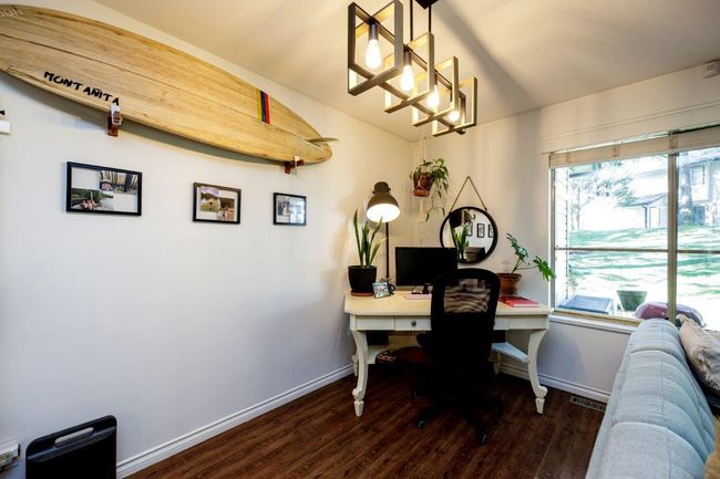 Home office featuring lofted ceiling, baseboards, and wood finished floors | Image 7