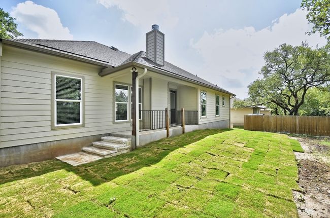 Back of house featuring a chimney and roof with shingles | Image 25