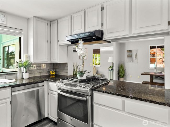 Light and bright kitchen with views of the pool. | Image 14