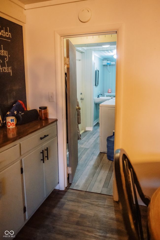 hallway featuring dark wood-style flooring and separate washer and dryer | Image 19