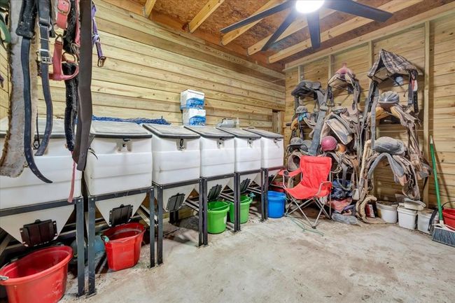 Tack room and feed concrete slab run with electricity and industrial ceiling fans. | Image 34