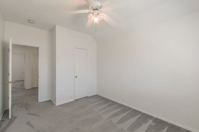 Unfurnished bedroom with baseboards, a ceiling fan, and carpet flooring | Image 17