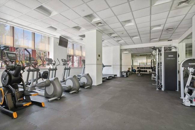 Gym featuring a paneled ceiling and floor to ceiling windows | Image 18