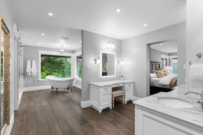 Full bath with connected bathroom, wood finished floors, vanity, baseboards, and recessed lighting | Image 21