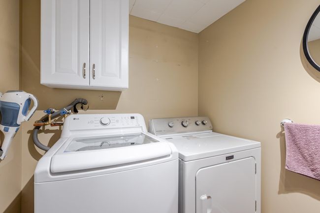 Laundry room with washer and clothes dryer and cabinet space | Image 34