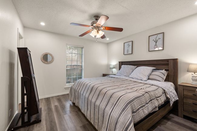 Bedroom featuring a textured ceiling, ceiling fan, baseboards, dark wood-style floors, and recessed lighting | Image 14