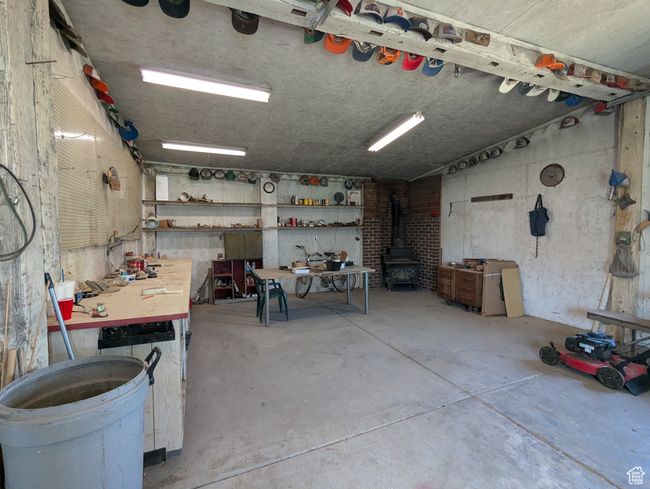 Garage with a workshop area and a wood stove | Image 28