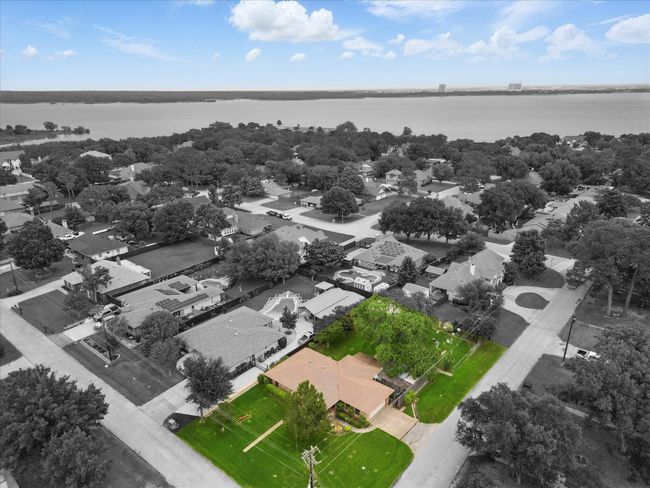 Aerial view of residential area featuring a large body of water | Image 5