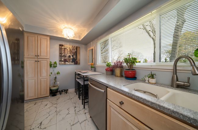 U-shaped kitchen has a large picture window with water views. | Image 9