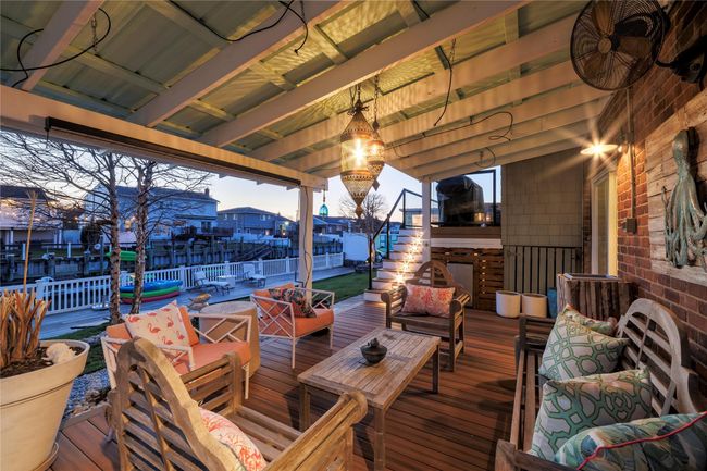 Deck with an outdoor hangout area and fence | Image 26
