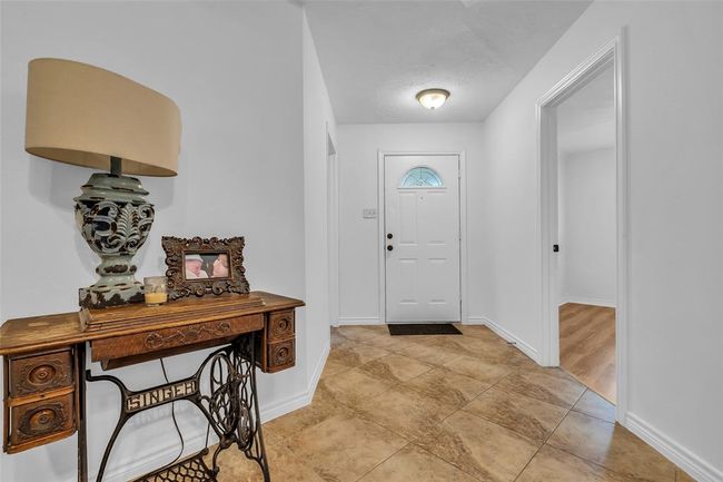 On each side of the entrance door are 2 bedrooms; one is towards the front of the house and the other is facing the backyard. | Image 8
