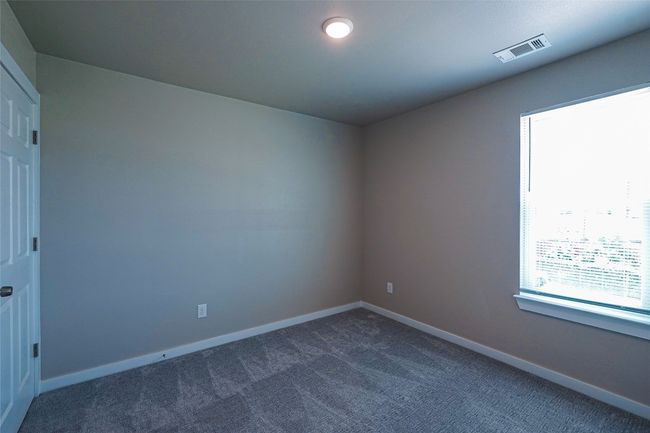 Spare room with dark carpet and baseboards | Image 24
