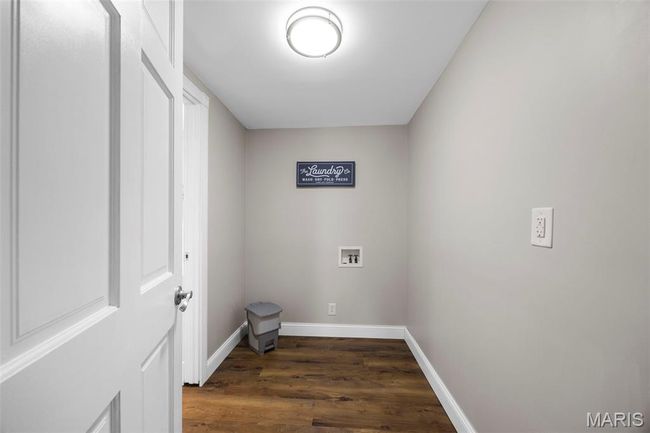 Laundry area featuring washer hookup and dark wood-style floors | Image 32