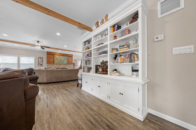 Dining space featuring radiator heating unit, baseboards, light wood-type flooring, recessed lighting, and crown molding | Image 13