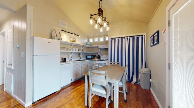 Unit A, Kitchen offers open shelving with dining option. | Image 5